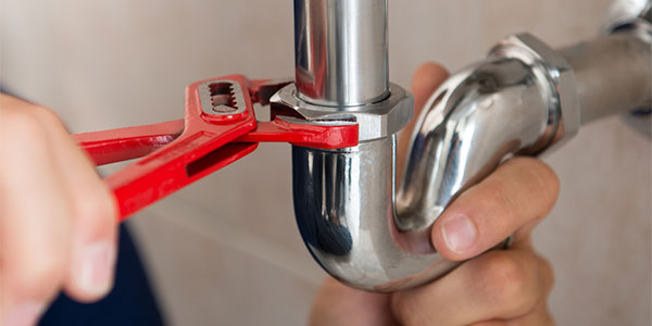 plumber fixing a pipe